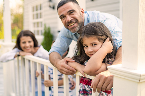 Image: Family leaning on fence outdoors