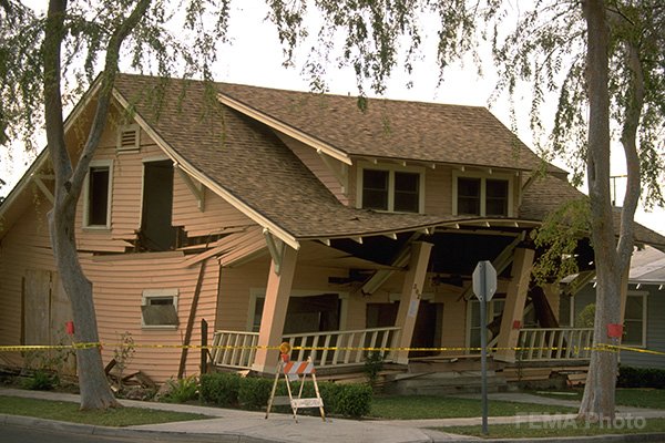 Image: House with front collapsed. This raised foundation house slid off its foundation during the Northridge earthquake. Photo credit: FEMA