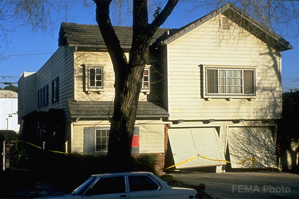 Image: Front of a house with earthquake damage. This house with a living space over the garage shows damage sustained during the Northridge earthquake. Photo credit: FEMA