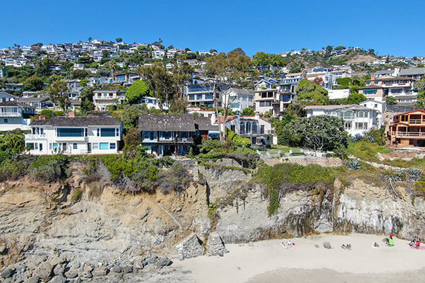 Image: House on Hill - Houses built on hillsides or steep slopes are often set on tall, narrow posts or columns, with walls stepping down the hill