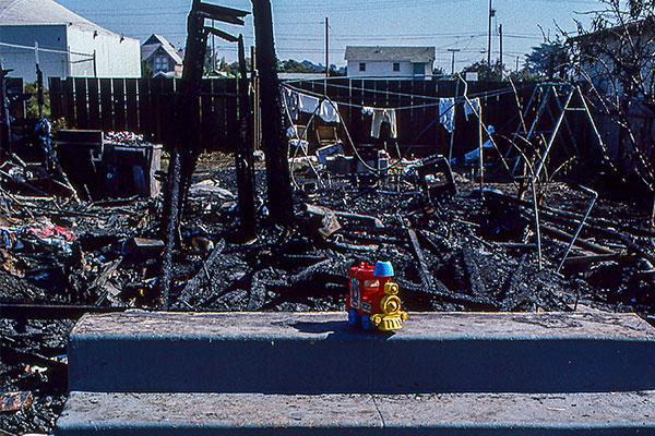 Image: House that has been destroyed with steps remaining and a toy train
